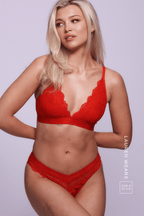 A woman standing with her hands on her back wearing a red lace lingerie set ^Lauren | Size: 32 A-B / 8