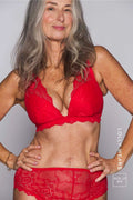 A woman modelling a red lace push up bra paired with matching red knickers ^ Lolly | Size: 32 E