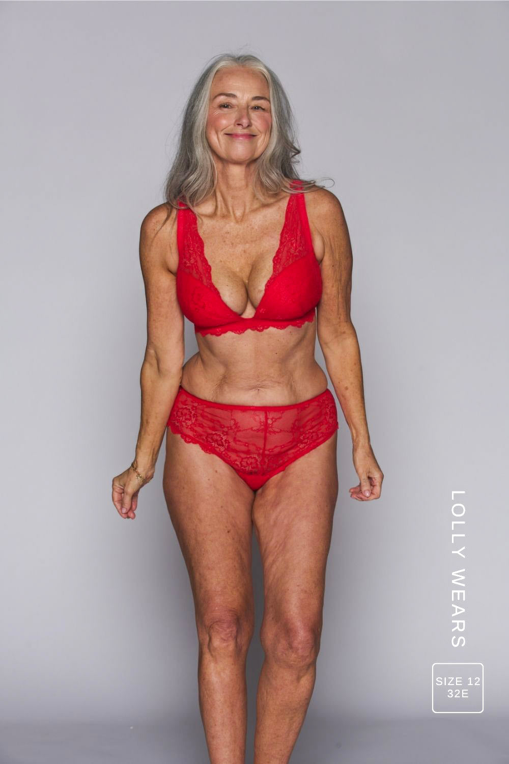 A woman wearing a red lace push up bra paired with matching red briefs 