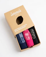 An image of three folded pairs of different coloured lace briefs packed inside a little lemonade dolls box