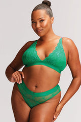 A woman wearing a matching green lingerie set in lace 