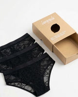 Three pairs of black lace briefs laying on each other besides a lemonade dolls box 