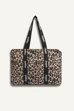 Leopard print tote bag with a strap featuring branding on a white background
