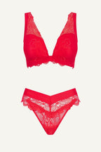 Red lace lingerie set on a white background