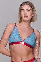 A woman wearing a blue check print mesh bralette paired with a matching brief 