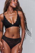 A woman modelling a black lace brief paired with the matching black lace bralette ^Hannah | Size 32 C  / 10