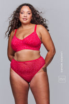 A woman wearing a pink leopard print lingerie set 