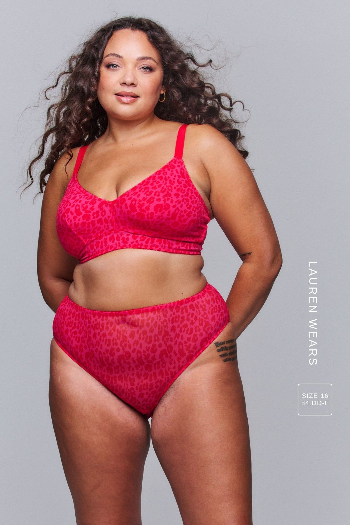 A woman wearing a pink leopard print lingerie set 