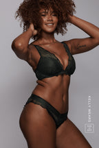 A woman modelling a black lace push up bra called "black slate"paired with matching knickers 