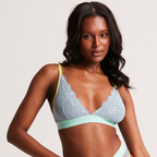 A woman wearing a blue lace bralette 