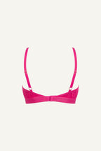 A ghost image of the back of a pink lace bralette called "iridescent" 