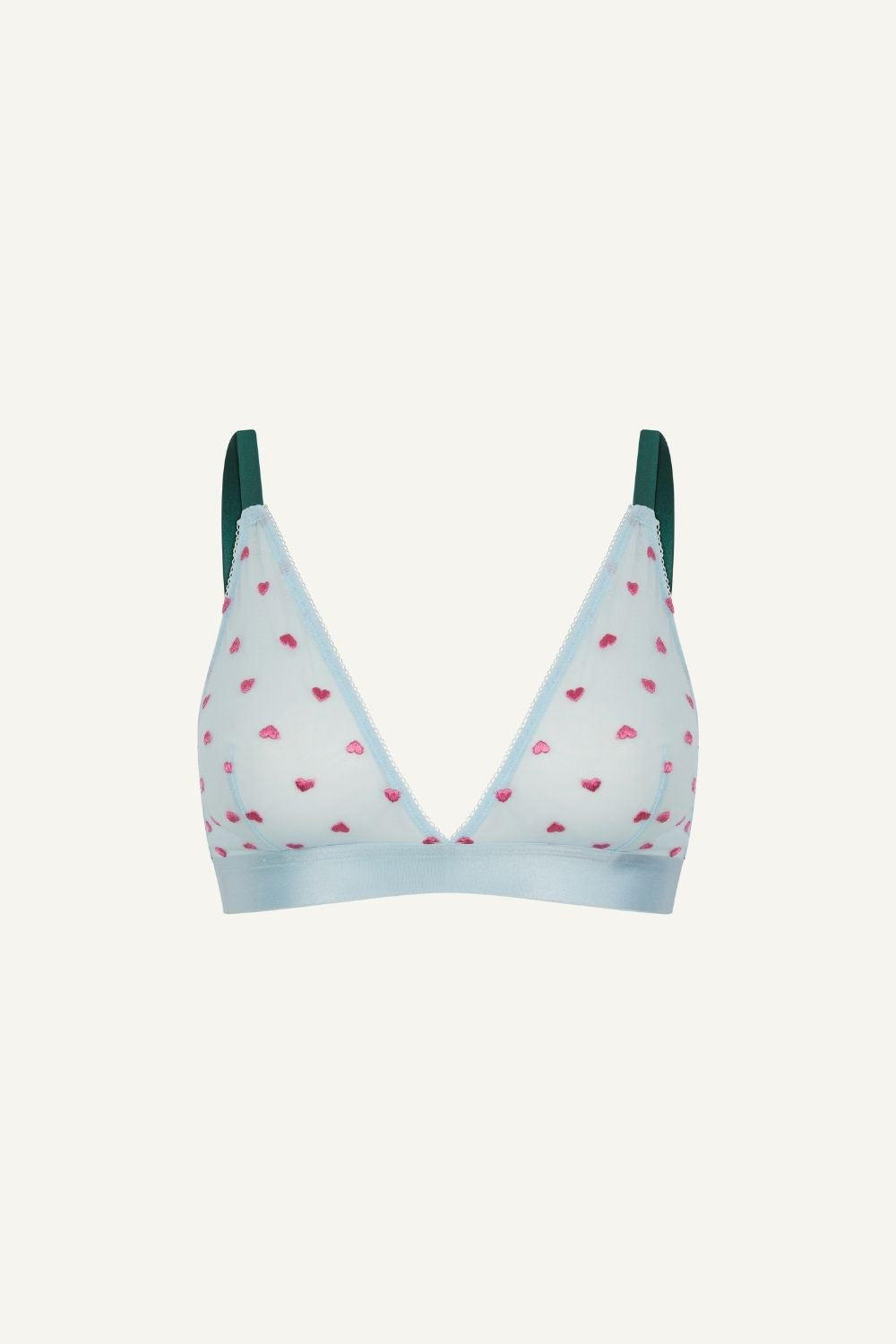 A ghost image of the front of a blue mesh bralette with pink hearts on it and green straps 