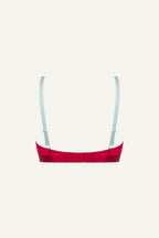 A ghost image of the back of a red mesh bralette with light blue straps 