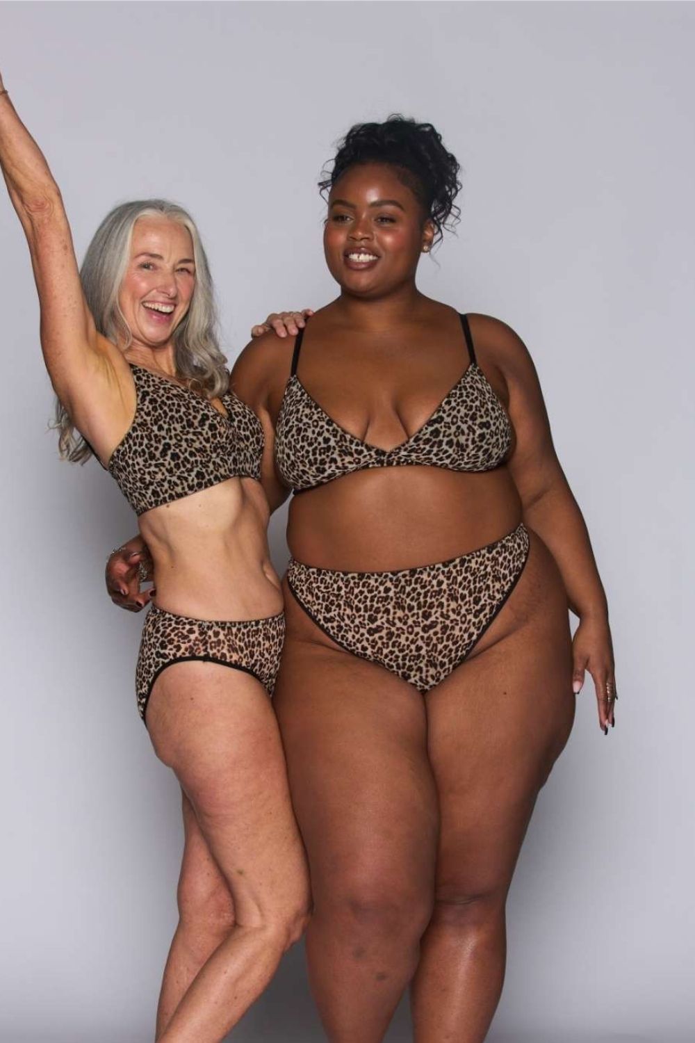 Two woman standing besides each other both wearing a leopard print mesh bralette (one fuller cup) paired with matching leopard print briefs 