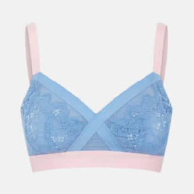 A light blue and pink underwire bra with floral lace cups and crossover straps, shown against a plain light gray background.