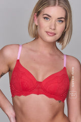 a woman modelling a red bra with pink straps 