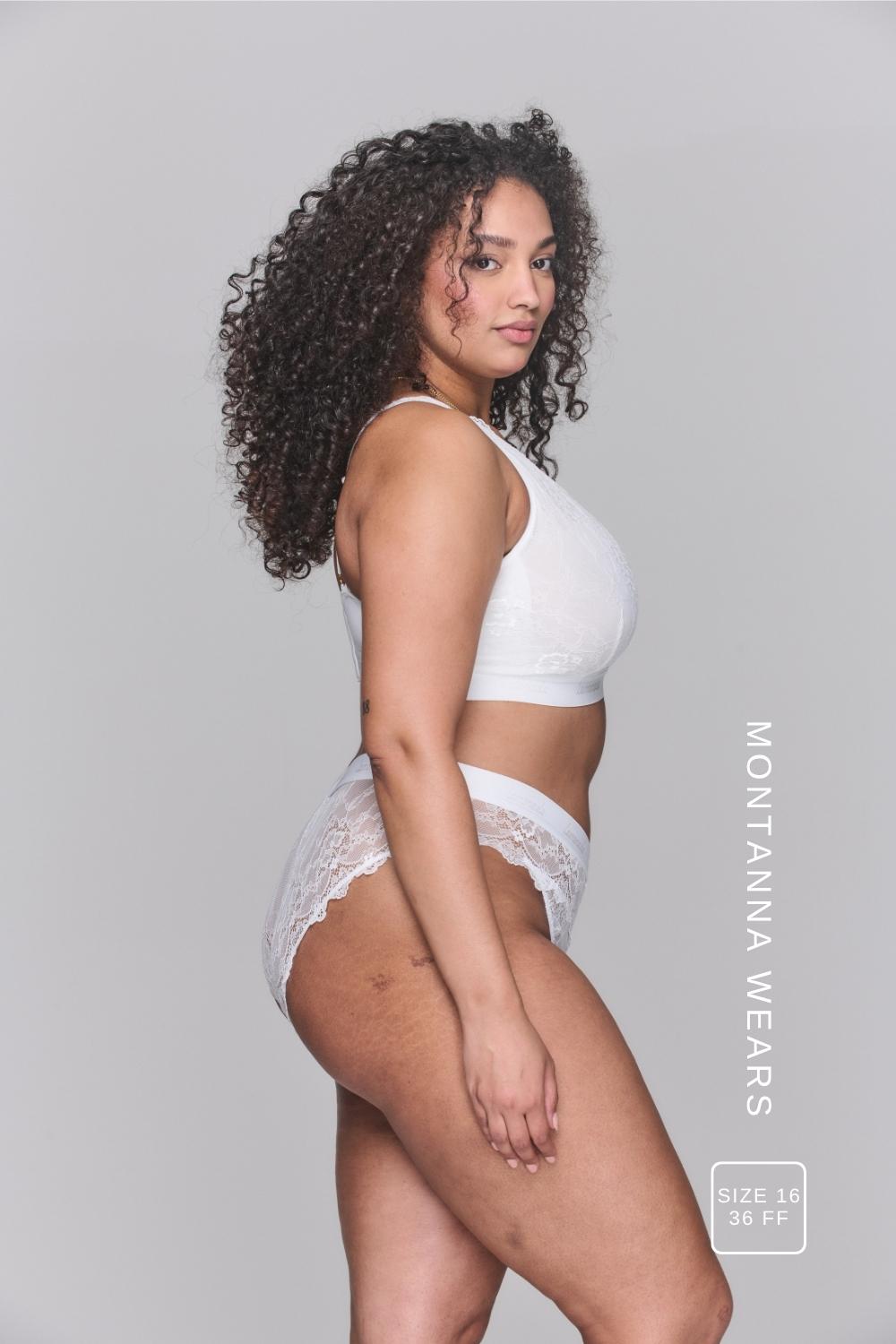A woman standing with her back to, wearing a white lace fuller cup bralette paired with a matching white brazilian 