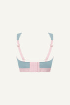 A ghost image of the back of a light blue lace fuller cup bralette with plight pink details on it 