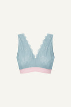 A ghost image of the front of a light blue fuller cup lace bralette with a light pink band 