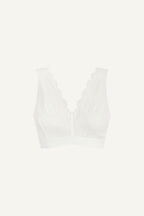 A ghost image of the front of a white lace fuller cup bralette 