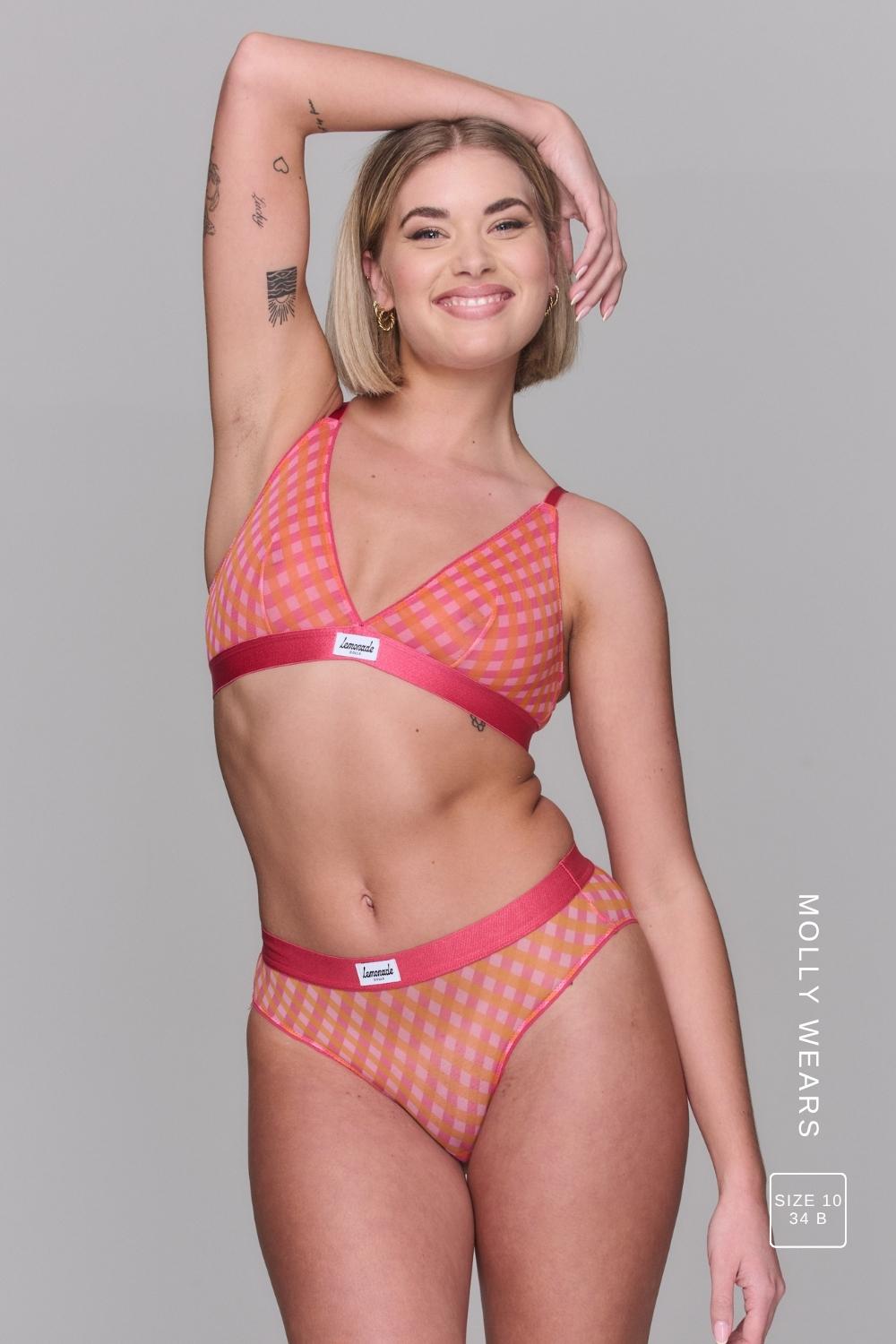 A woman modelling a soft mesh check print bralette paired with the matching brief