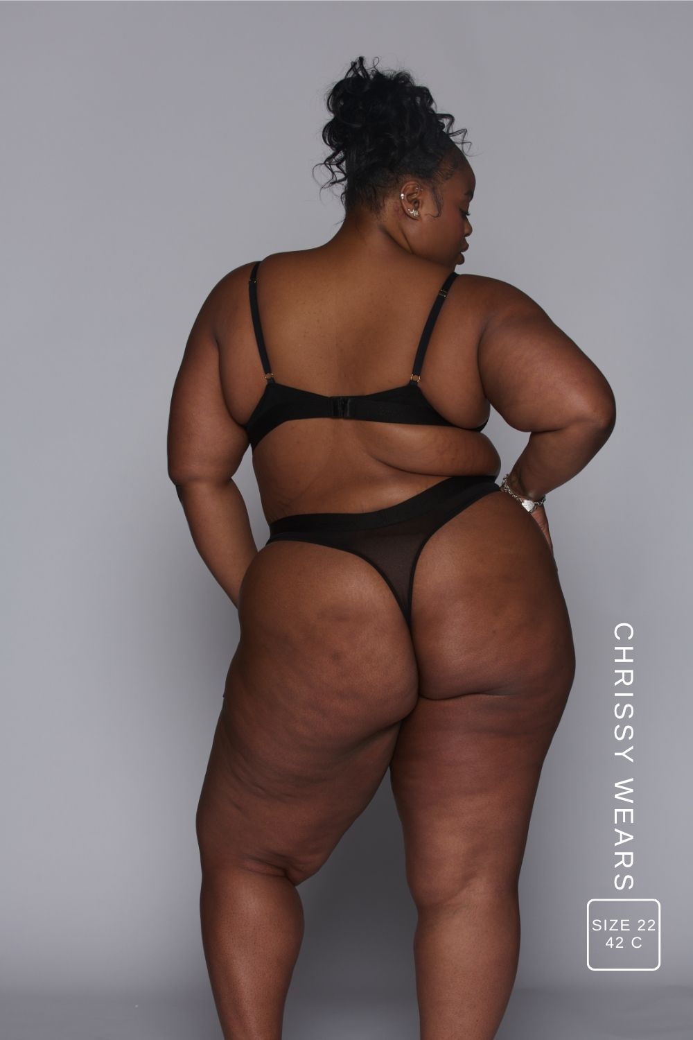 Person wearing a black lingerie set on a plain background with 'Chrissy Wears' branding.
