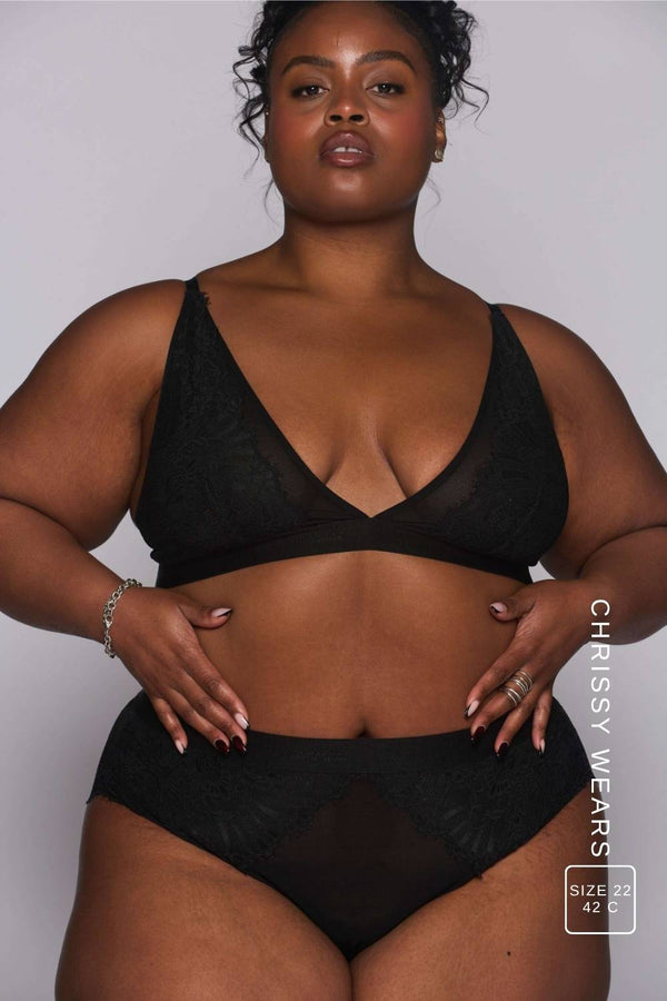a woman modelling a black lace bralette paired with matching lace knickers ^Chrissy | Size: 42 C / 22