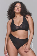 A woman modelling a black lace and mesh fuller cup bra paired with matching knickers ^Montana | Size: 36 FF / 16