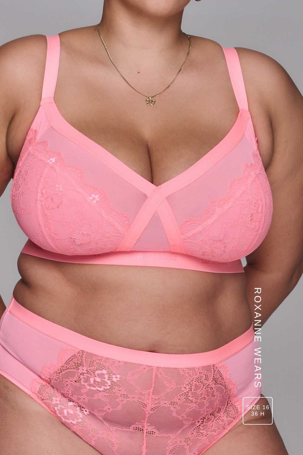 Woman wearing a high support coral bra called The One paired with matching knickers