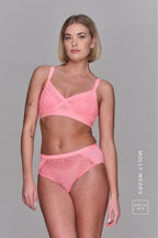 A woman wearing the Signature Lace and Mesh HW brief - Coral paired with the matching bralette 