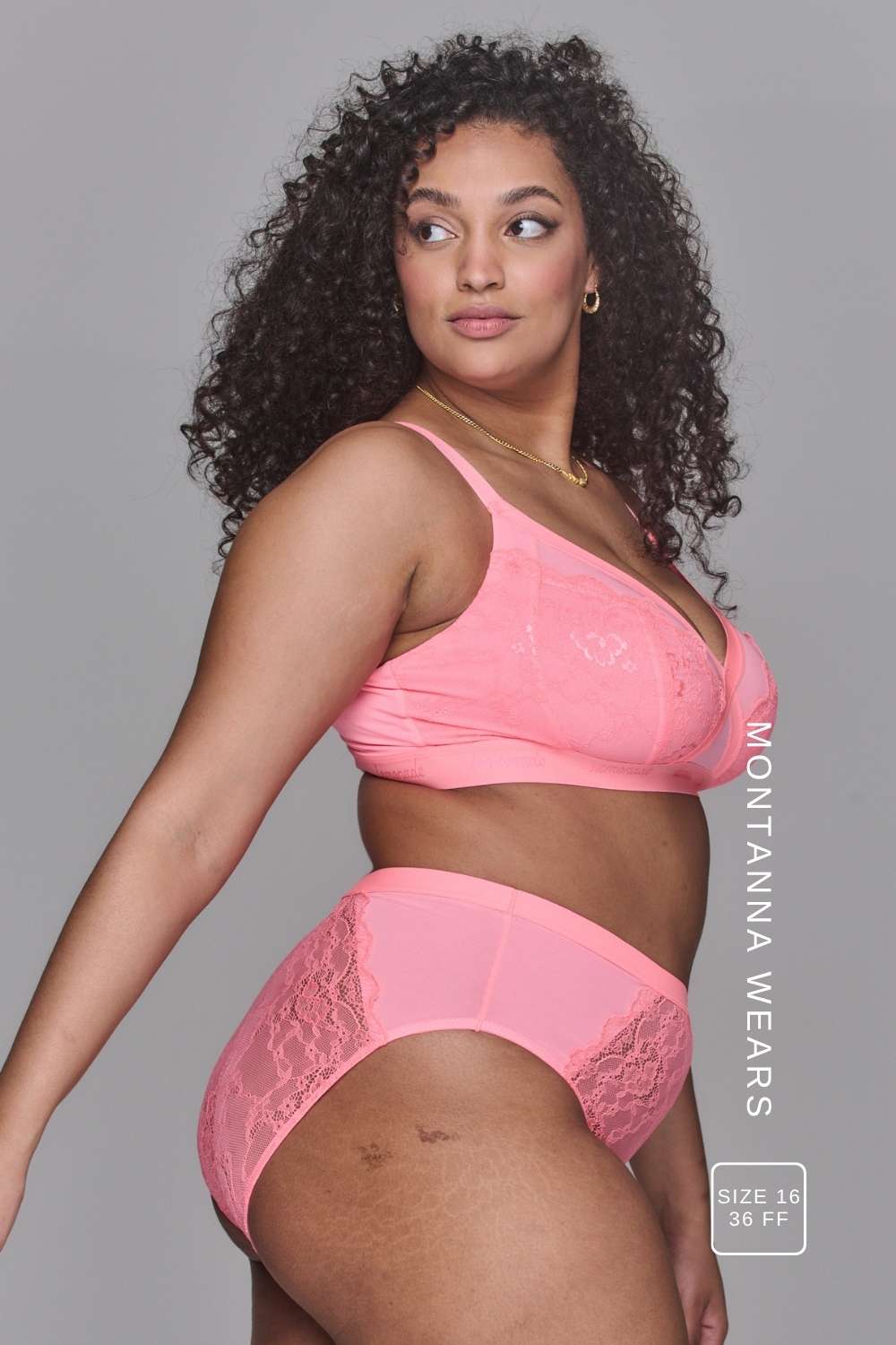 Woman wearing a high support coral bra called The One paired with matching knickers
