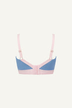 A ghost image of a pink and blue high support lace bra called The One 