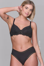 Woman wearing a black bra and soft black pants - bra is called The Flex