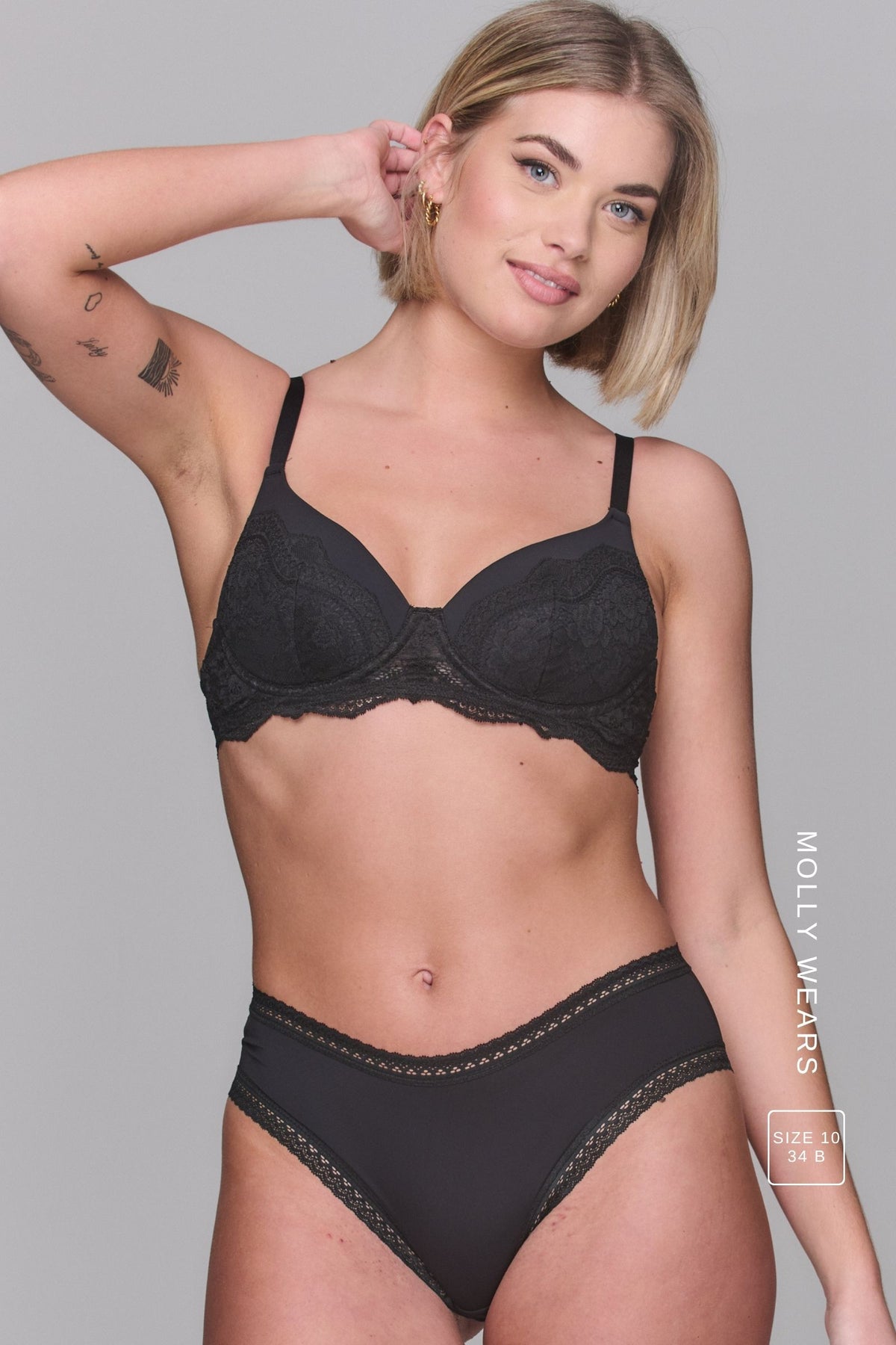 Woman wearing a black bra and soft black pants - bra is called The Flex