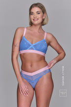 A woman wearing a matching pink and blue lace lingerie set ^Molly | Size: 34 B / 10