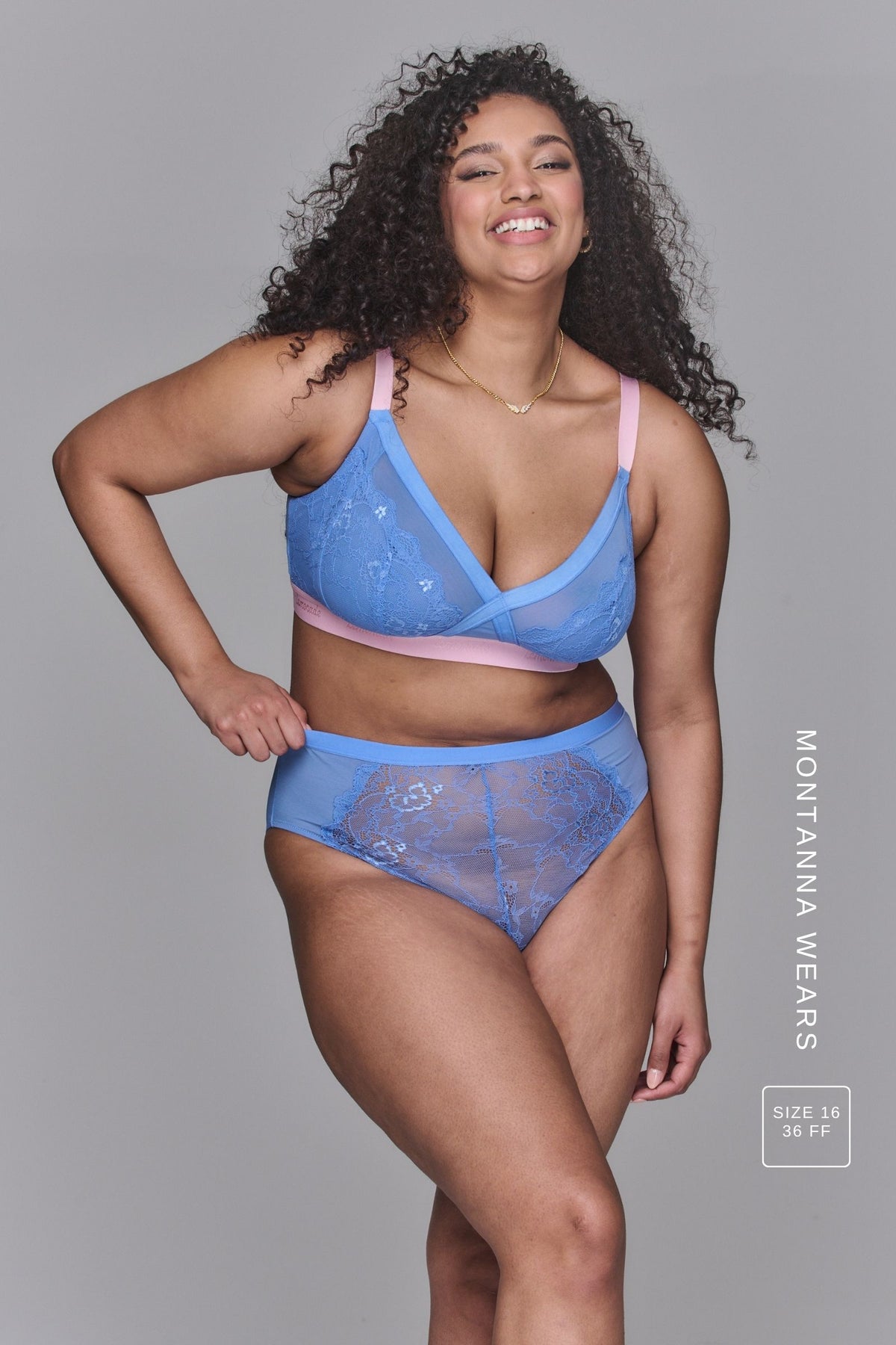 A woman wearing a pink and blue high support lace bra called The One paired with matching knickers 