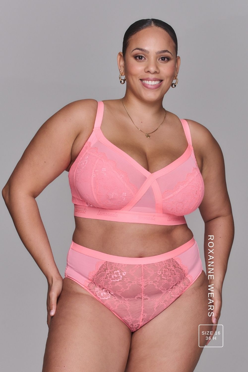 Woman wearing a high support coral bra called The One paired with matching knickers ^Roxanne | Size: 36 H / 16