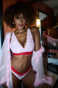A woman wearing a light pink lace fuller cup bralette 