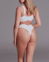 A woman wearing a white modal thong 