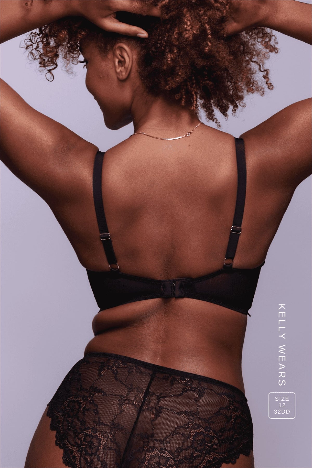 A woman standing with her back turned modelling a Black Lace Push Up paired with a Black Lace Brief 