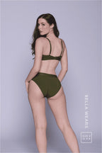 A woman standing with her back to wearing a matching khaki green lingerie set 