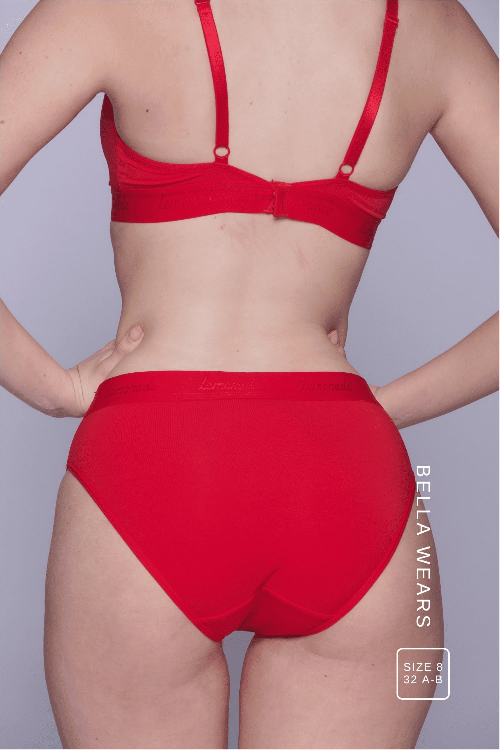 A close up image of the back of a woman wearing a red mesh brief 