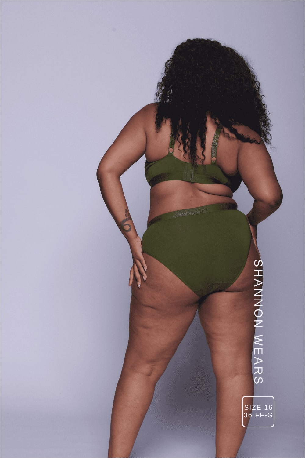 A woman standing with her back to wearing a matching khaki lingerie set 