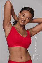 A woman wearing a red fuller cup bralette 