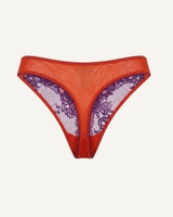 A ghost image of the back of an orange and purple lace embroidered thong 