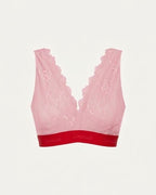 A ghost image of the front of a light pink lace fuller cup bralette with a red band 