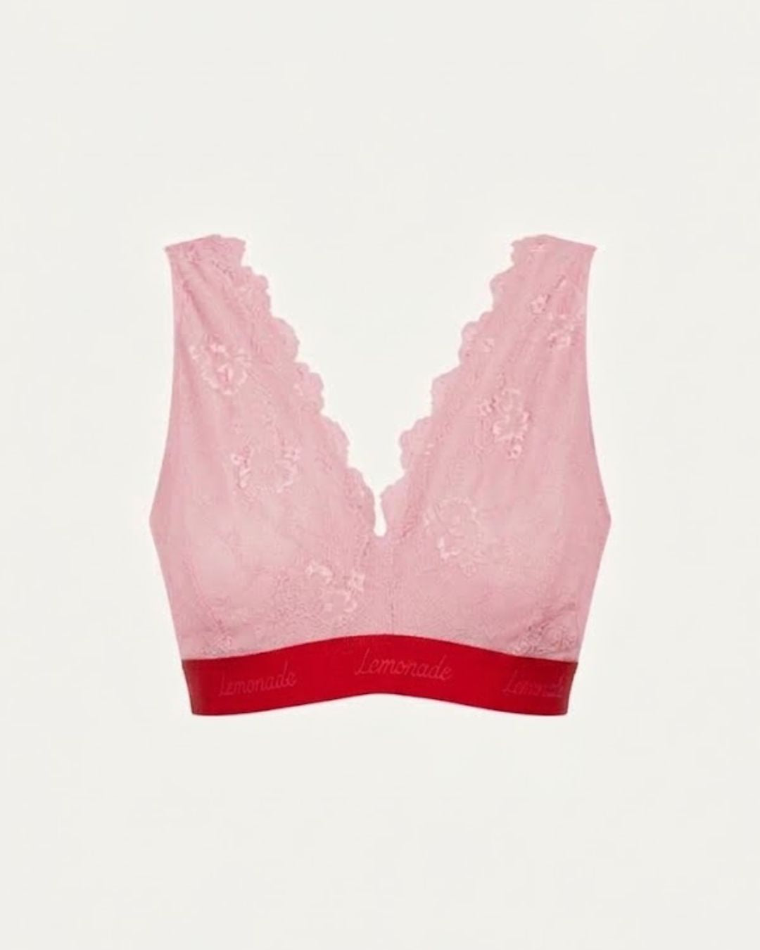 A ghost image of the front of a light pink lace fuller cup bralette with a red band 