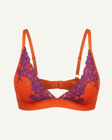A ghost image of the front of an orange and purple lace embroidered bralette 