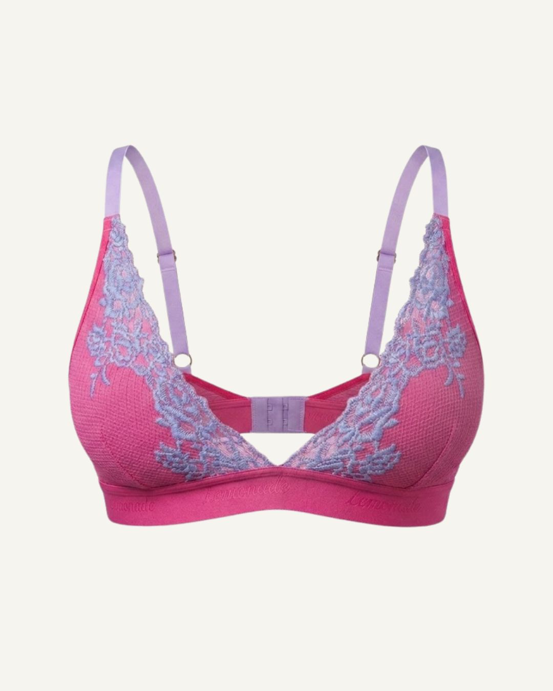 A ghost image of the front of a pink and purple lace embroidered bralette 