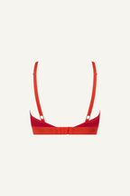 A ghost image of the back of a red lace bralette 
